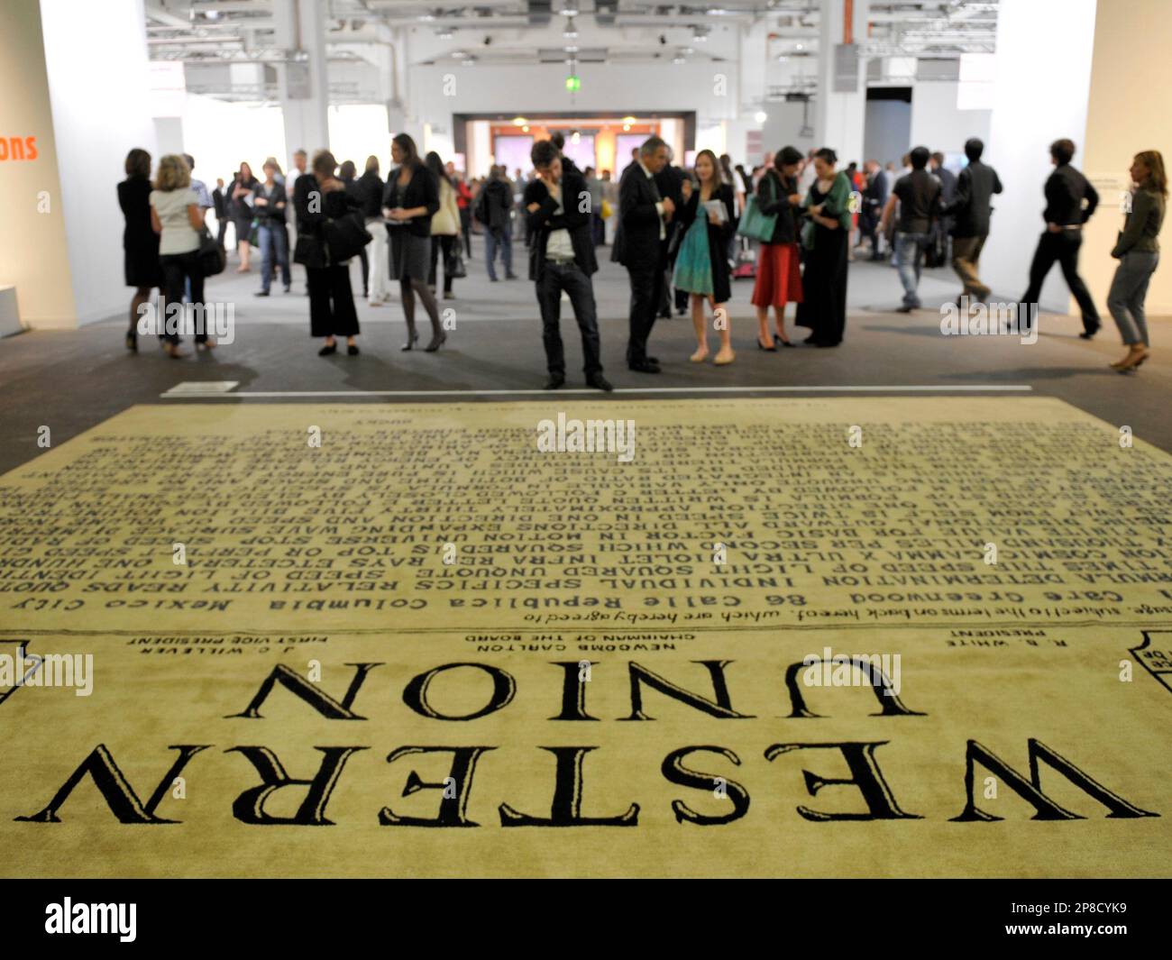 A visitor stands behind the installation 