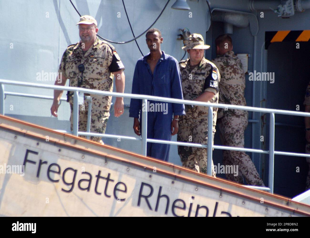 file-this-april-8-2009-file-photo-shows-german-marine-officers-escorting-one-of-the-seven-suspected-somali-pirates-on-board-the-german-naval-warship-frigatte-rheinland-pfalz-before-they-were-handed-over-to-the-kenyan-authorities-theres-not-a-warship-for-miles-a-small-pirate-skiff-is-speeding-toward-you-and-theres-no-way-the-creaking-tub-youre-on-can-outrun-the-bandits-how-long-do-you-wait-before-you-shoot-its-just-one-of-many-possible-dilemmas-facing-an-increasing-number-of-private-security-companies-who-offer-armed-escorts-known-in-the-industry-as-shipriders-from-somali-pira-2P8D8N2.jpg