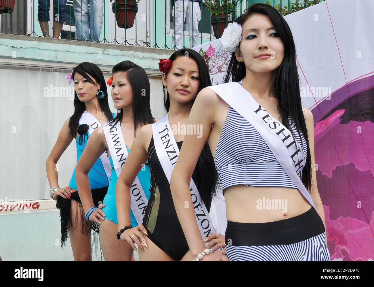 Participants of the Miss Tibet 2009 beauty pageant pose during the swimsuit round in Dharmsala, India, Friday, June 5, 2009. The winner will be announced in the final to be held on Sunday. (AP Photo/Tsering Topgyal) Stock Photo
