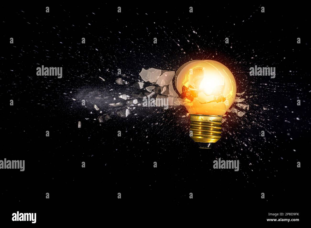 small light bulb exploding against a black background Stock Photo Alamy