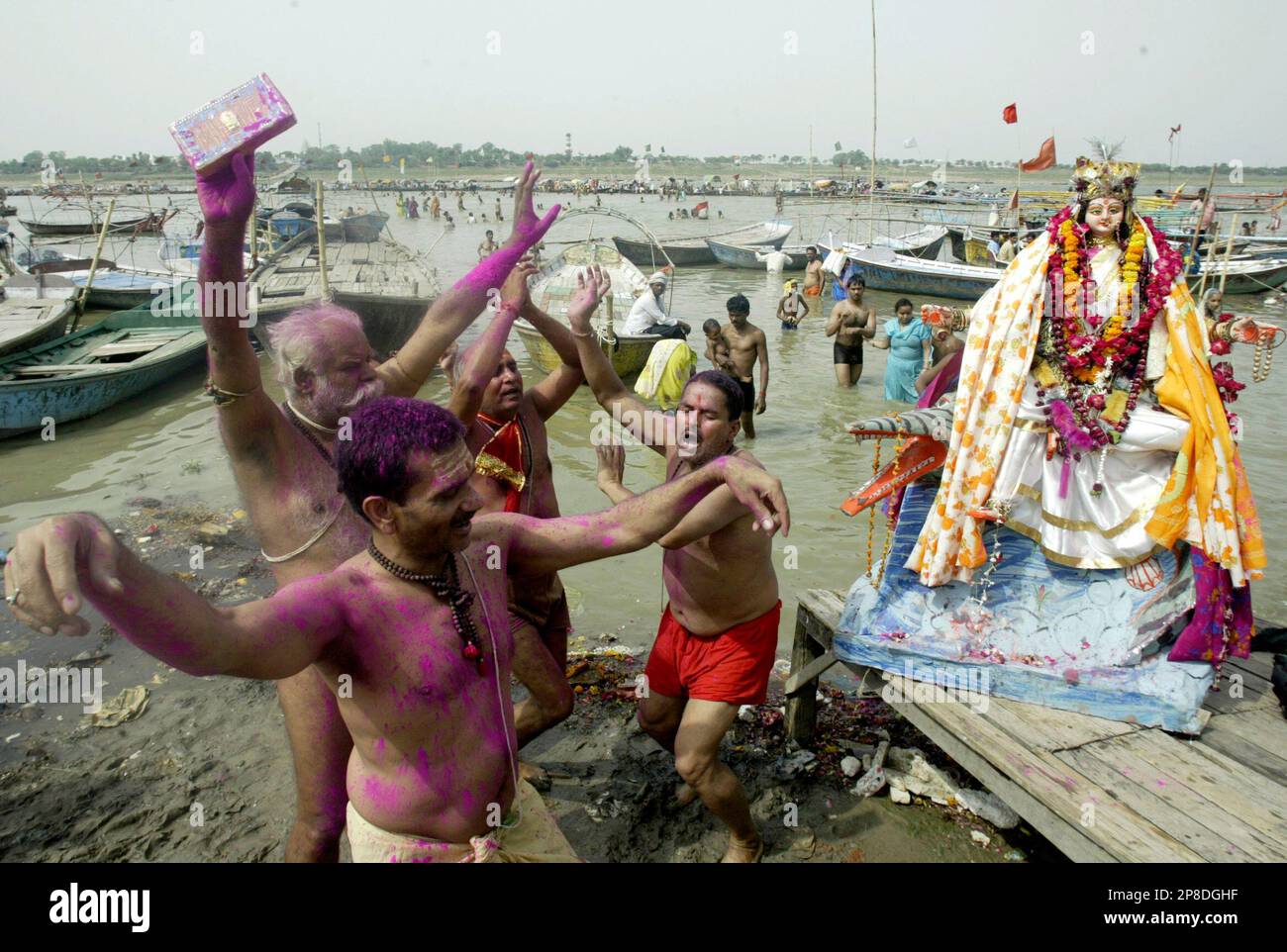 Hindu devotees perform a ritual dance before immersing an idol of the ...