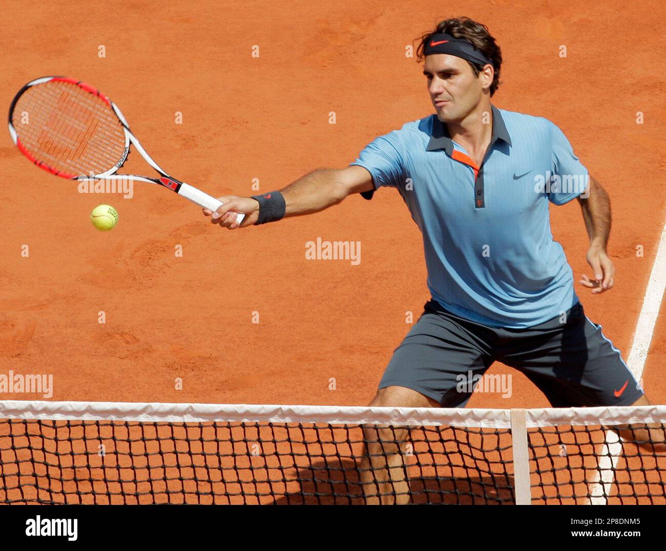 Switzerland's Roger Federer volleys the ball to Germany's Tommy Haas during  their fourth round match of the French Open tennis tournament at the Roland  Garros stadium in Paris, Monday June 1, 2009. (
