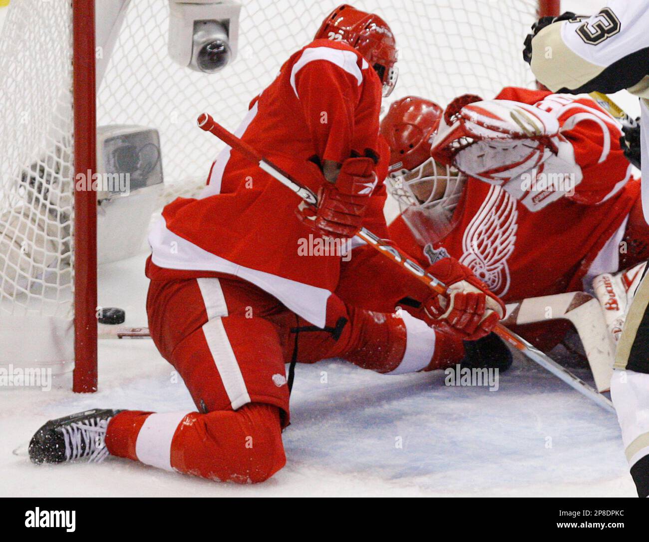 Detroit Red Wings goalie Chris Osgood, right, and teammate Brad Stuart watch as a goal by Pittsburgh Penguins Evgeni Malkin goes into the net during first period of Game 2 of the