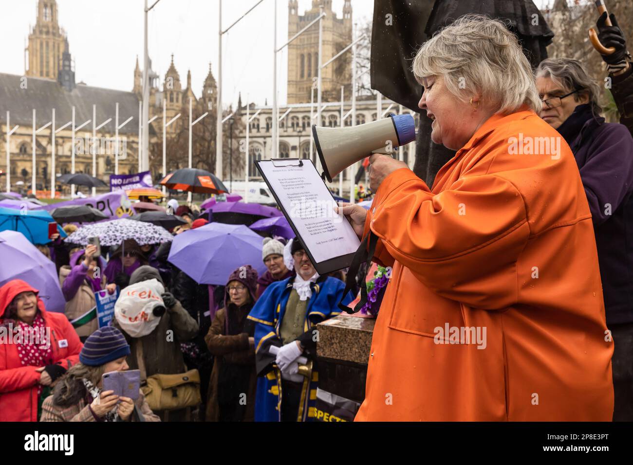 Westminster, London, UK, March 8 2023, Trudy Howson, LGBT Poet Laureate reading her poem, Pension Plea, at the Waspi demonstration on International Wo Stock Photo