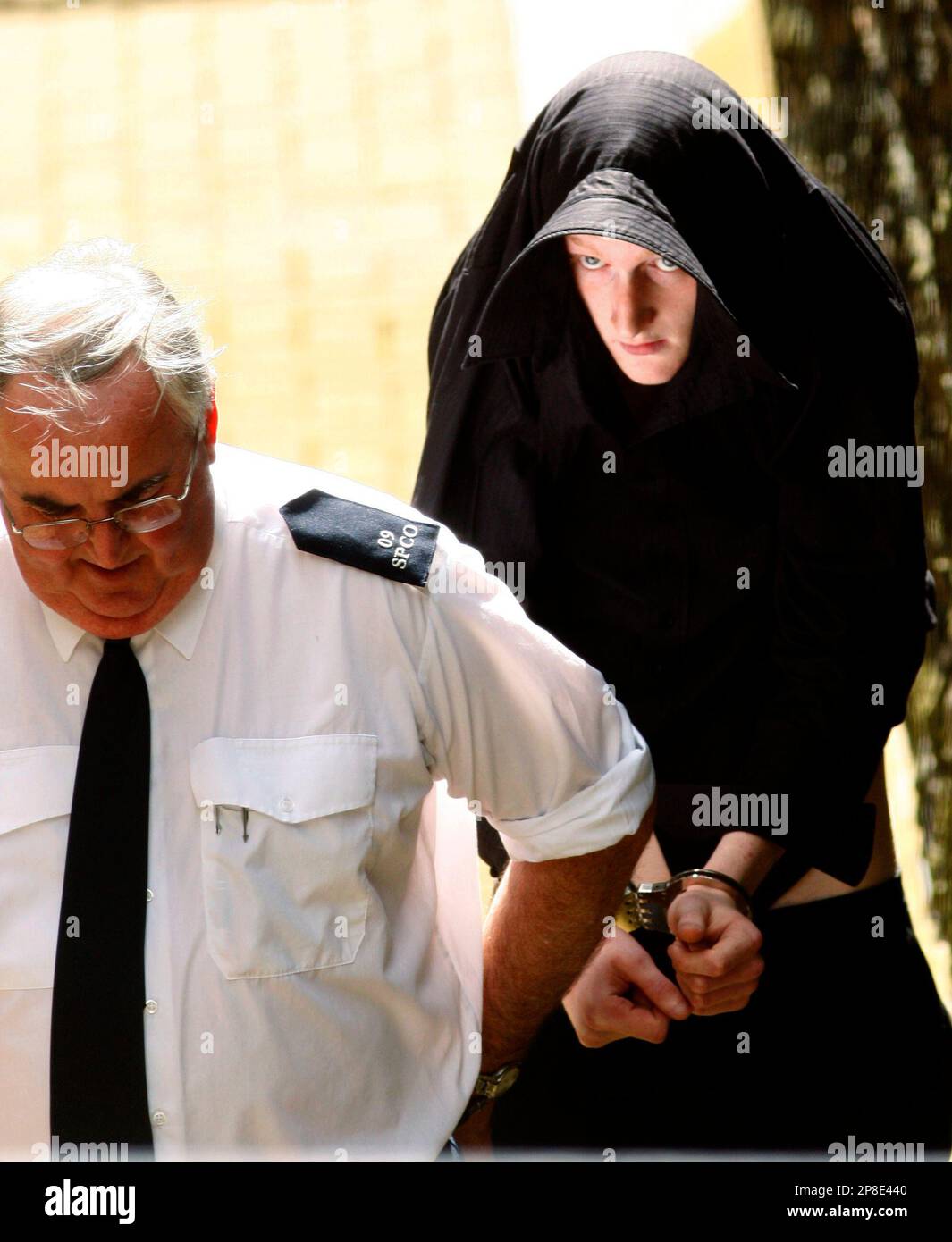 David Craig Cochrane is led away from Ballymena Court, Northern Ireland, Thursday, May, 28, 2009