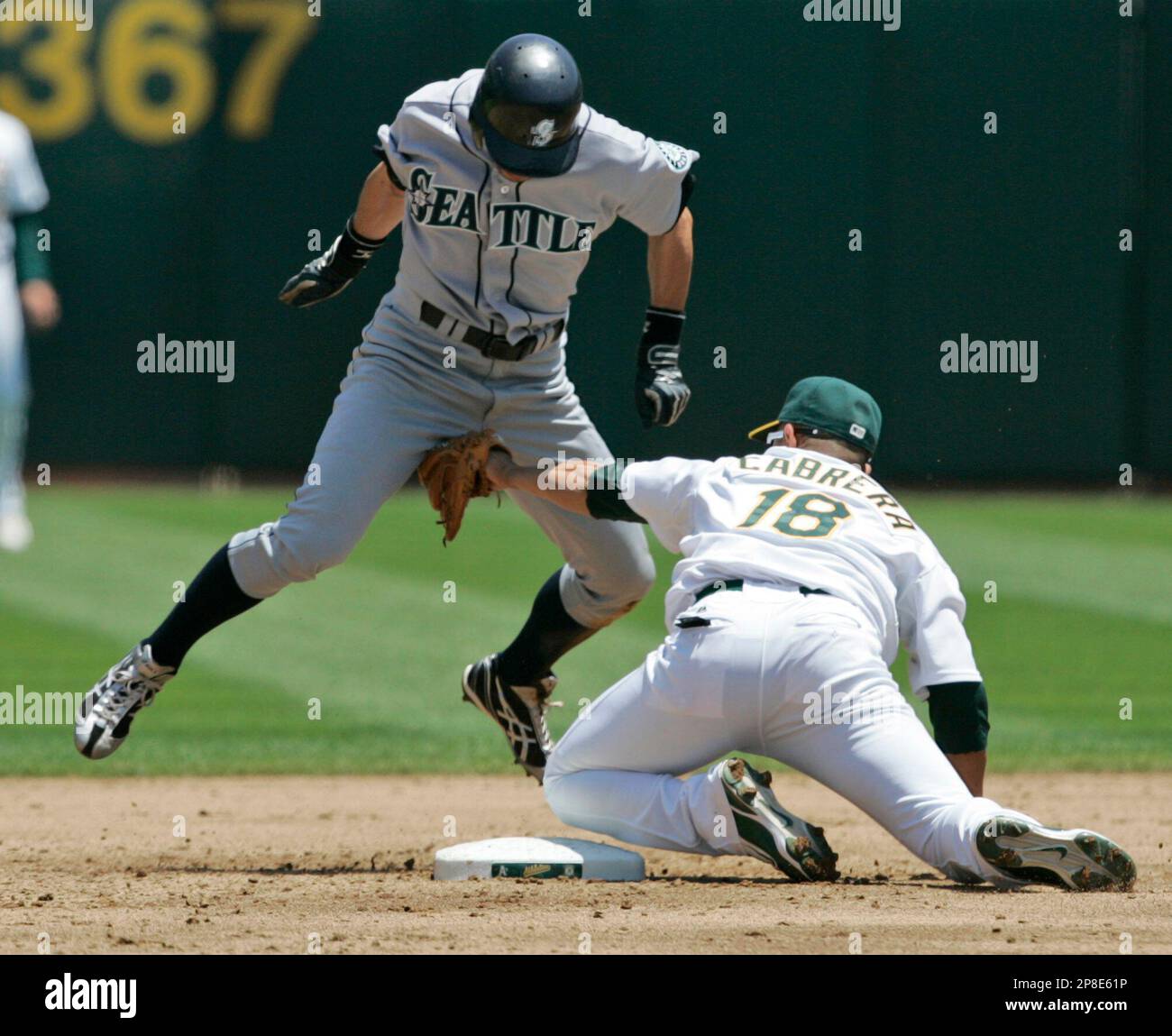 Oakland Athletics shortstop Orlando Cabrera reaches to put the tag