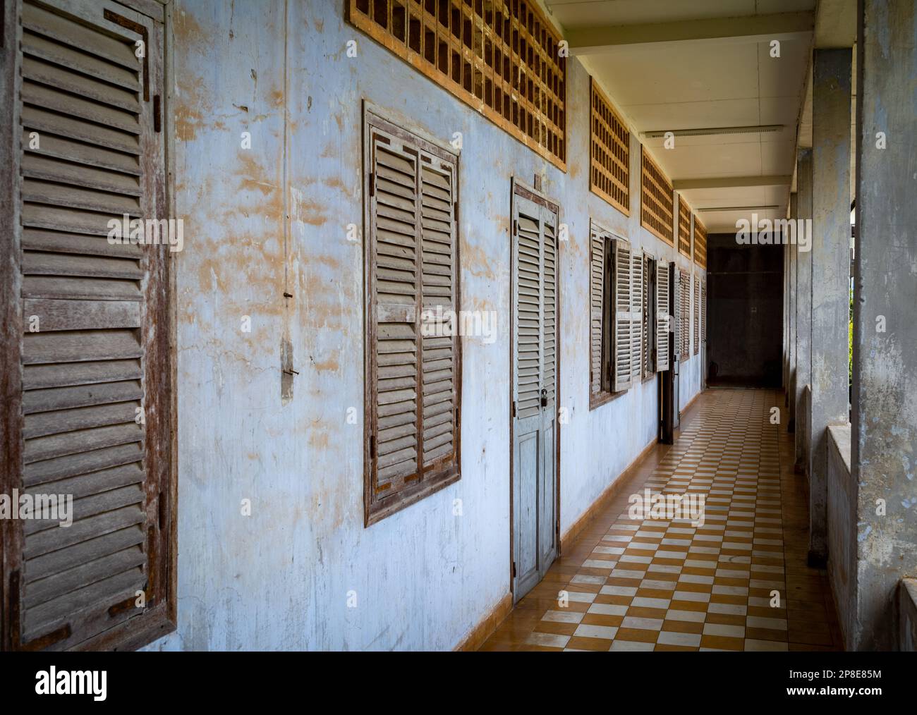 A corridor past former classrooms in the notorious Tuol Sleng S-21 torture and genocide prison museum in Phnom Penh, Cambodia. More than 18,000 peopl Stock Photo
