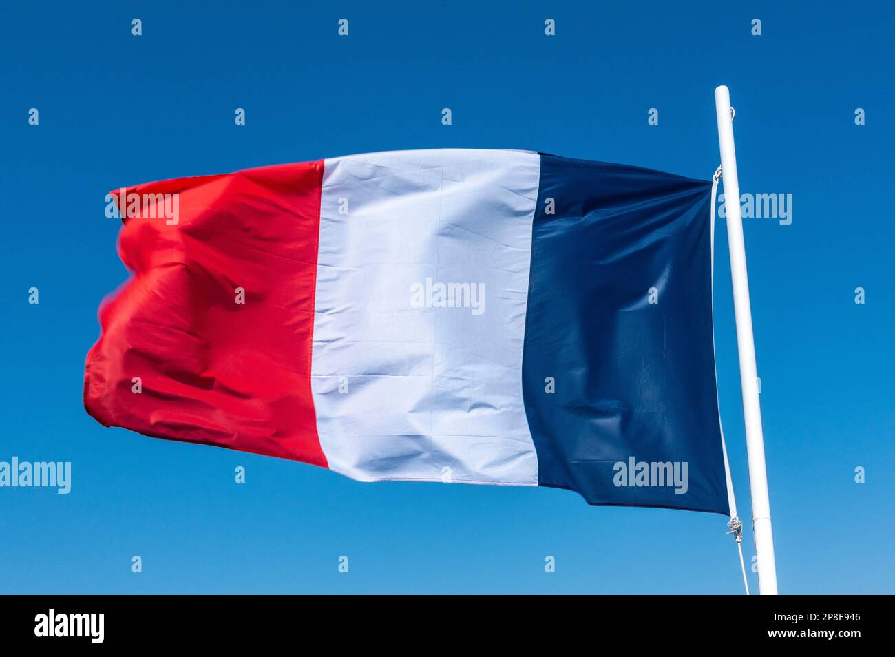 French flag at full mast waving in the wind Stock Photo
