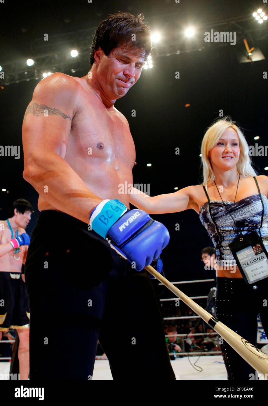 former major league mvp player jose canseco leaves the ring with his girl friend heidi northcott after losing his debut match against super heavyweight hong man choi of south korea in the mixed martial arts dream 9 card at yokohama arena in yokohama japan tuesday may 26 2009 hong beat canseco with a knockout in the 1st round ap photoitsuo inouye 2P8EAX6