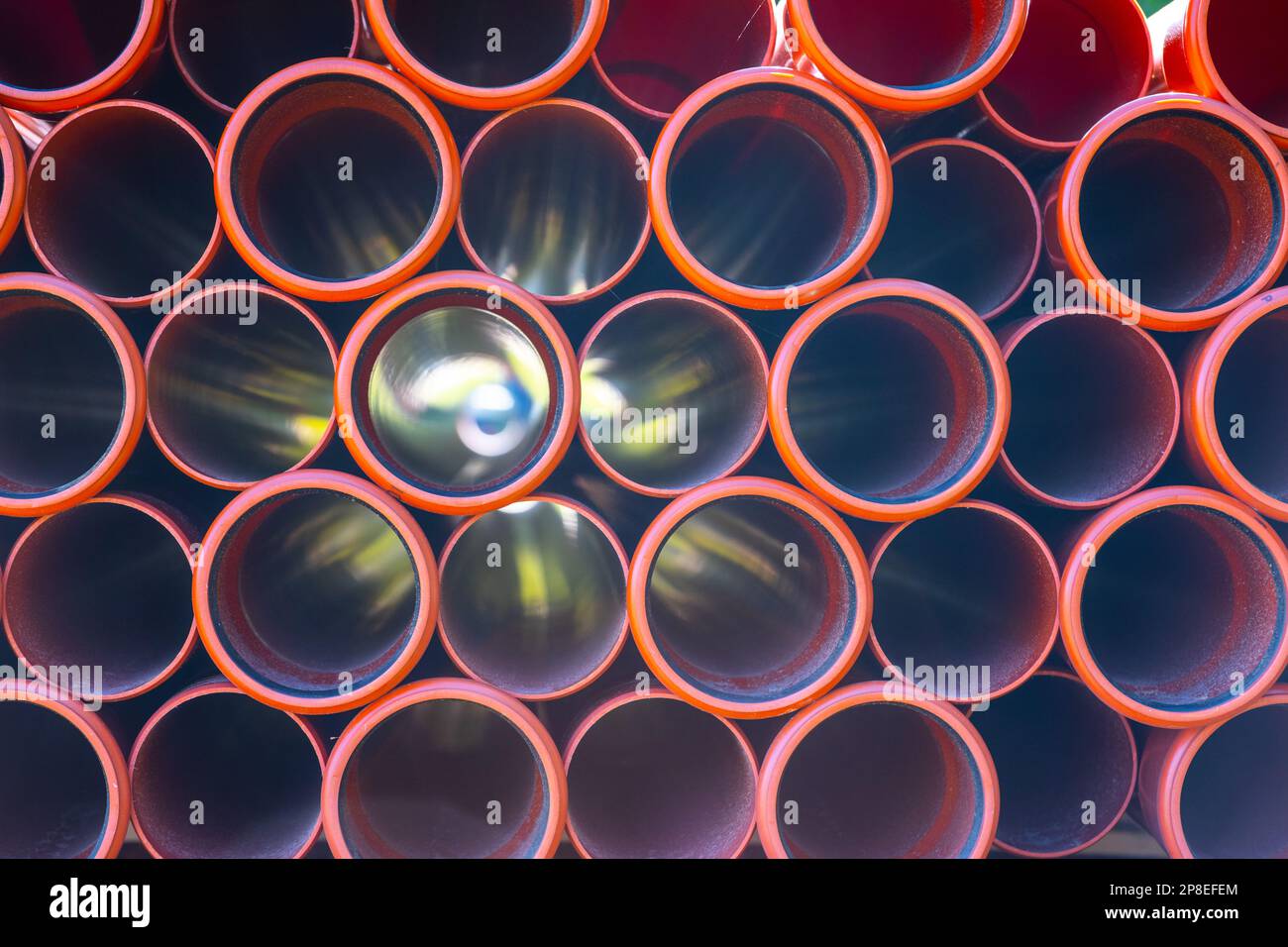 Large pile of orange plastic PVC pipes Stock Photo Alamy