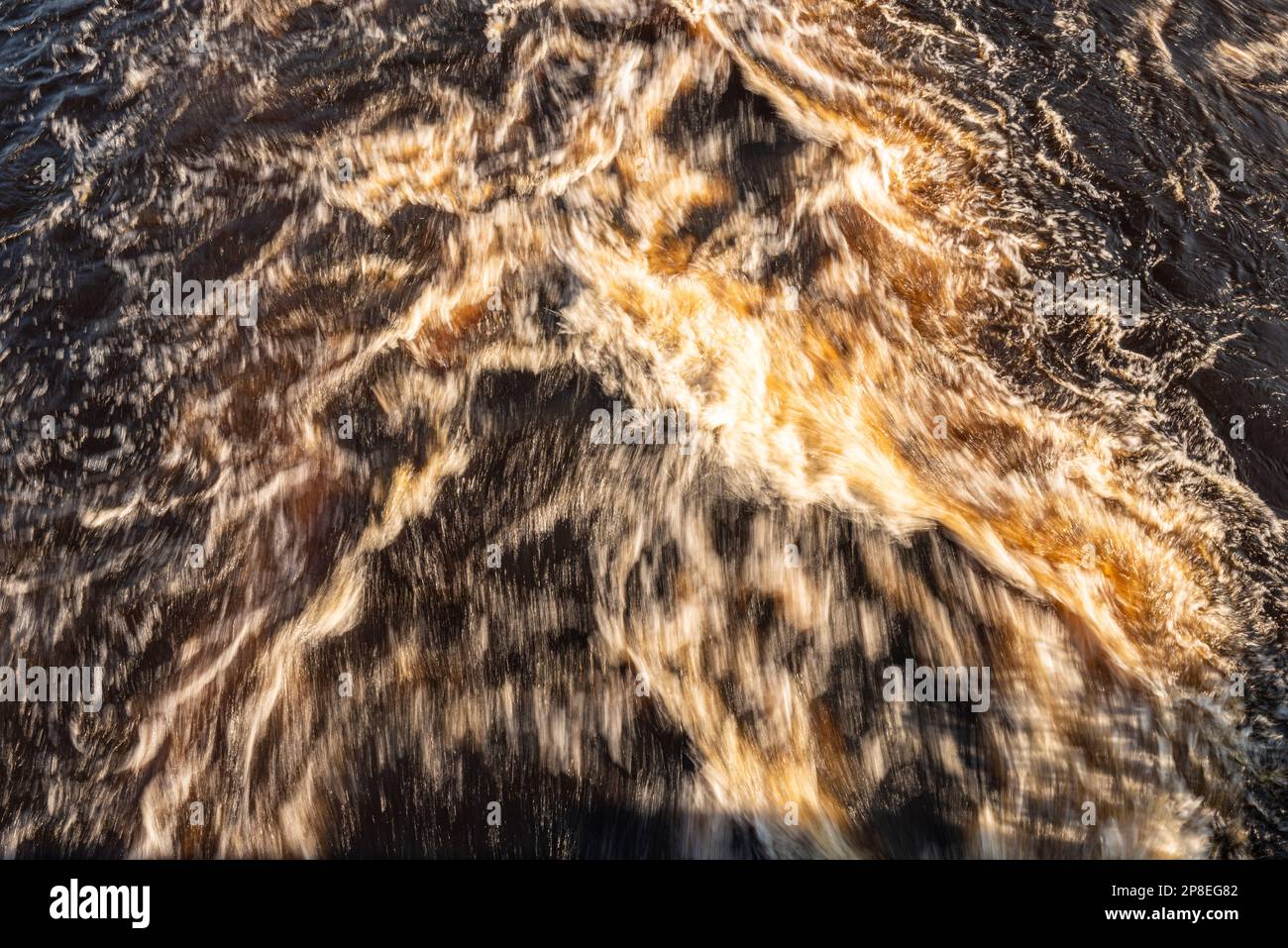 Brown water rushing down a river Stock Photo - Alamy