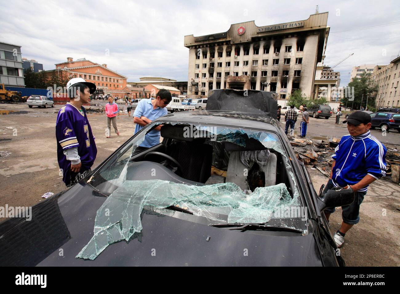 Mongolia Riots FILE - In this July 3, 2008 file photo, residents look at a damaged car ...