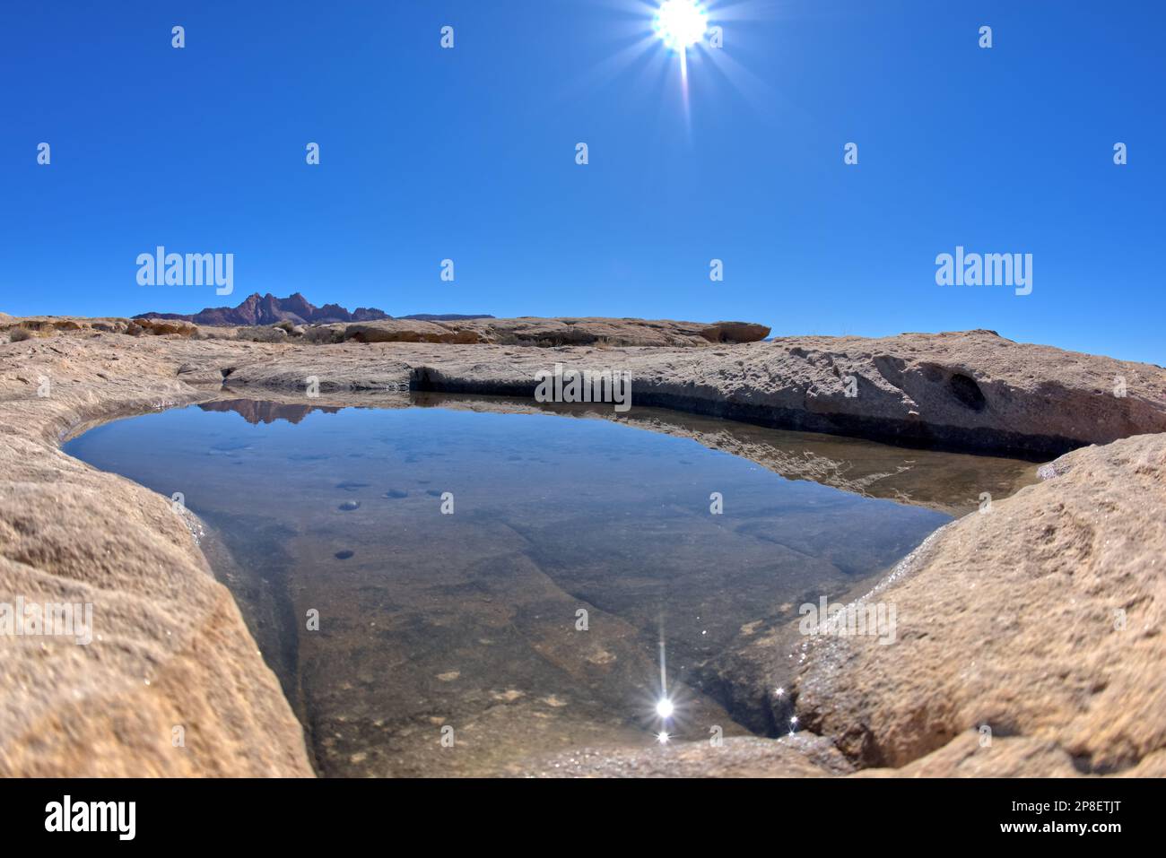 Sunburst over rock Pool at Johnson Point, Glen Canyon National Recreation Area, Arizona, USA Stock Photo