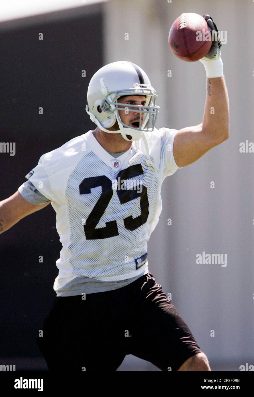 An Oakland Raiders player holds up a helmet at the start of a NFL