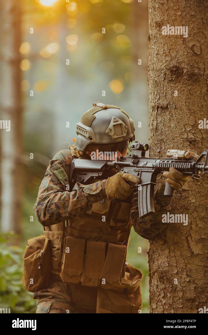 A modern warfare soldier on war duty in dense and dangerous forest ...