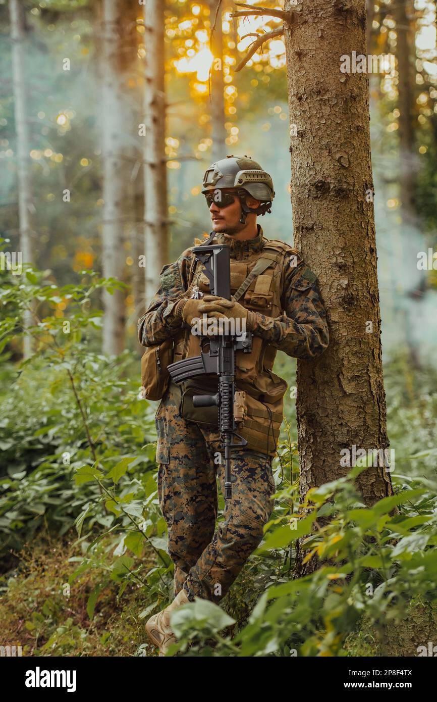 A modern warfare soldier on war duty in dense and dangerous forest ...
