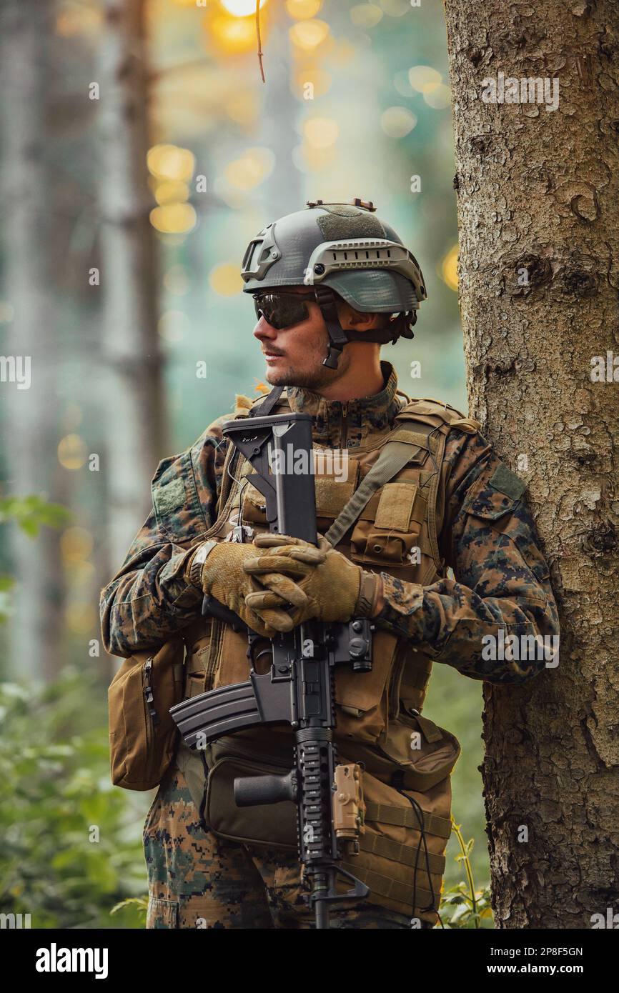 A modern warfare soldier on war duty in dense and dangerous forest ...