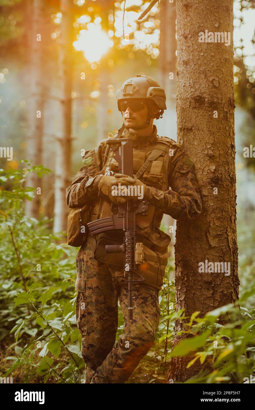 A modern warfare soldier on war duty in dense and dangerous forest ...
