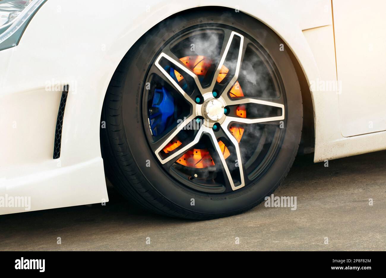 Close up shot of a burning disc brake in a wheel of a sports car Stock