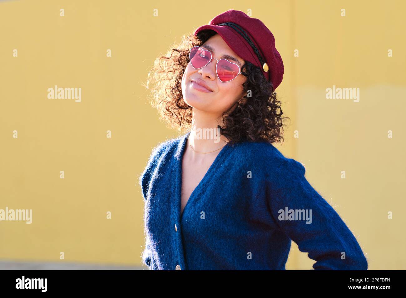 Cute woman with hat and sunglasses looking at camera Stock Photo