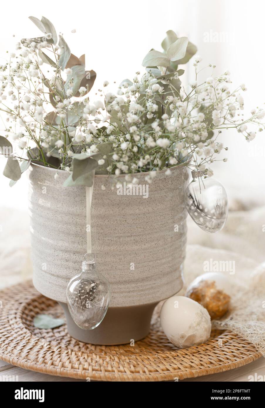 Light Easter composition with Easter eggs and gypsophila flowers. Stock Photo