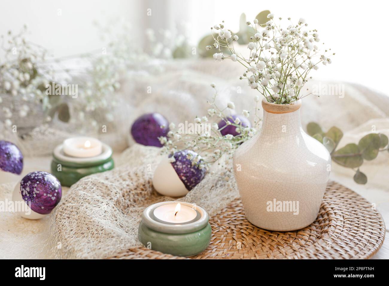 Easter composition with gypsophila flowers and Easter eggs. Stock Photo