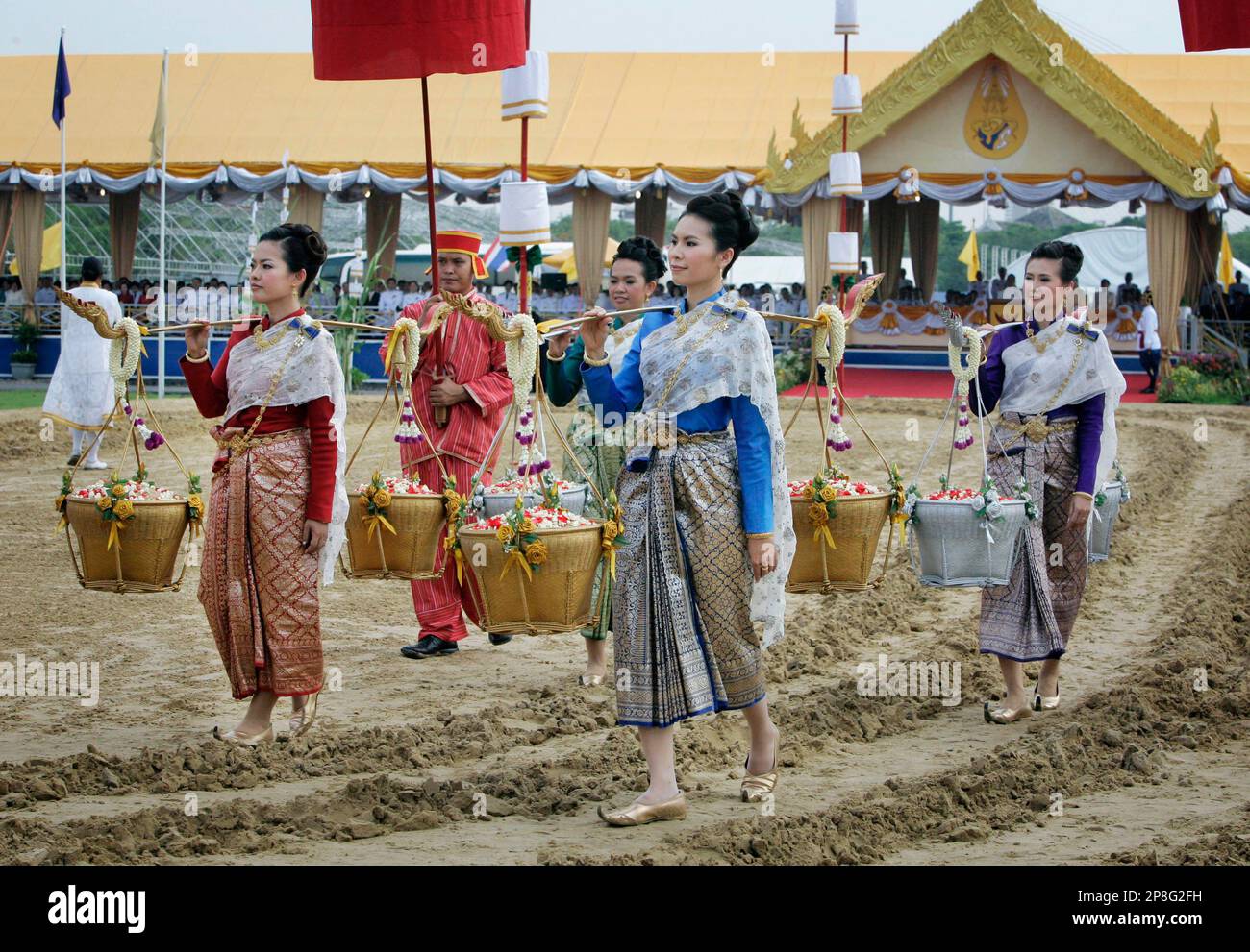 Royal attendants carry sacred seed rice during royal ploughing ...