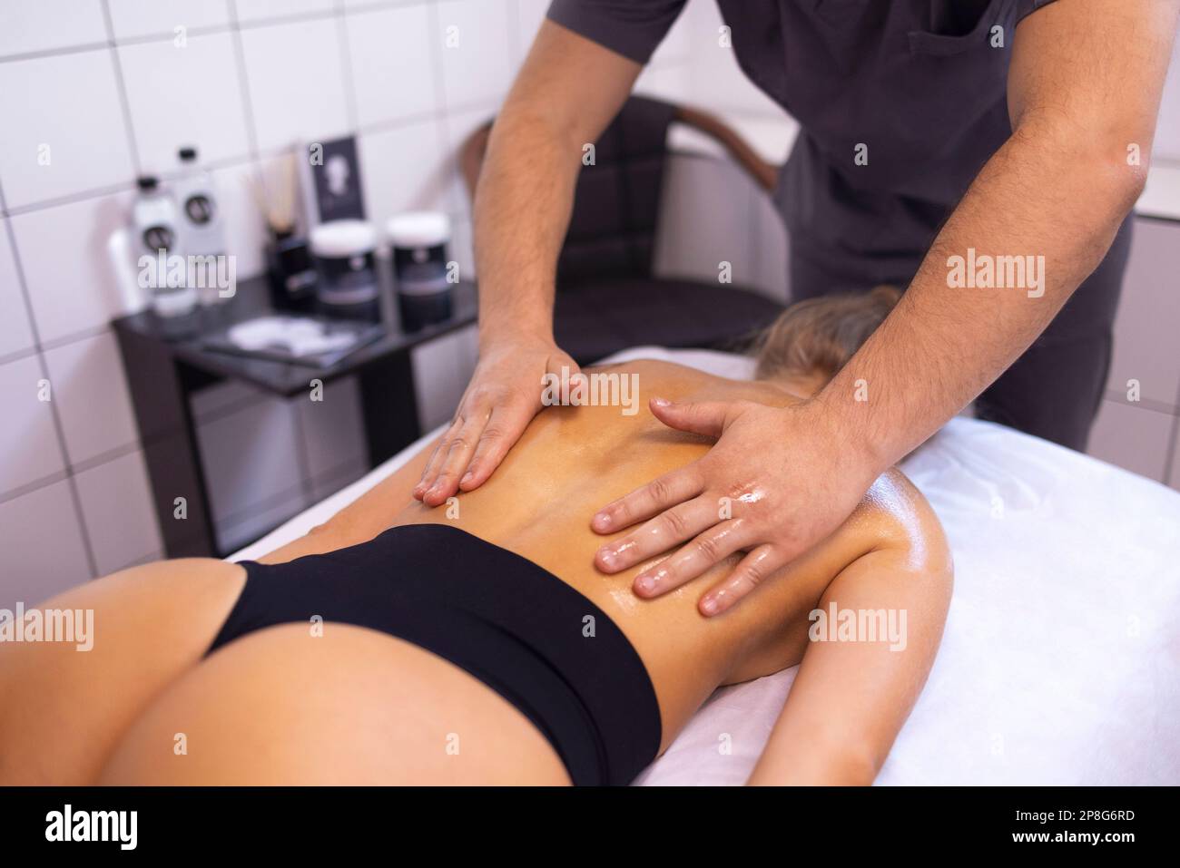 https://c8.alamy.com/comp/2P8G6RD/happy-young-caucasian-girl-getting-back-massage-in-spa-salon-neat-hands-of-male-masseuse-with-orange-manicure-beautiful-smiling-woman-gets-relaxatio-2P8G6RD.jpg