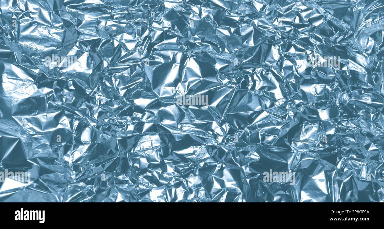 Silver metallic crumpled aluminum foil background Stock Photo