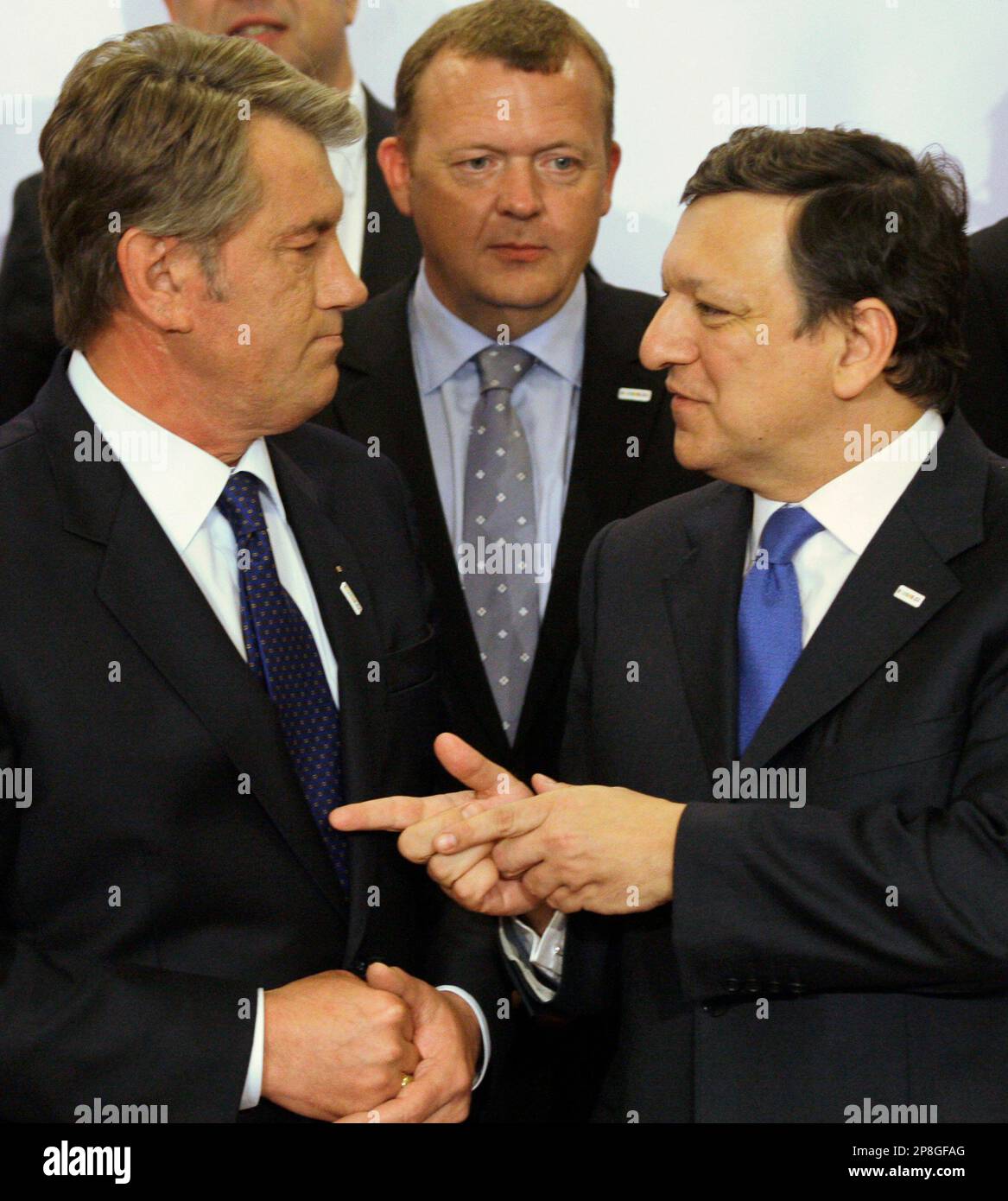 Danish Prime Minister Lars Loekke Rasmussen, back, looks on as