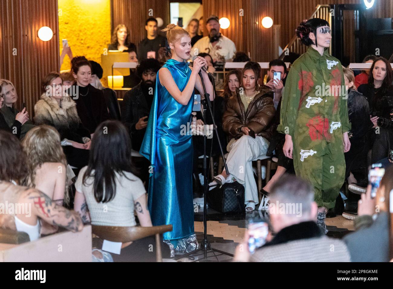 VIN+OMI fashion show in collaboration with King Charles III, creating fashion from recycling. Megan Rutherford singing during event in 100 Shoreditch Stock Photo