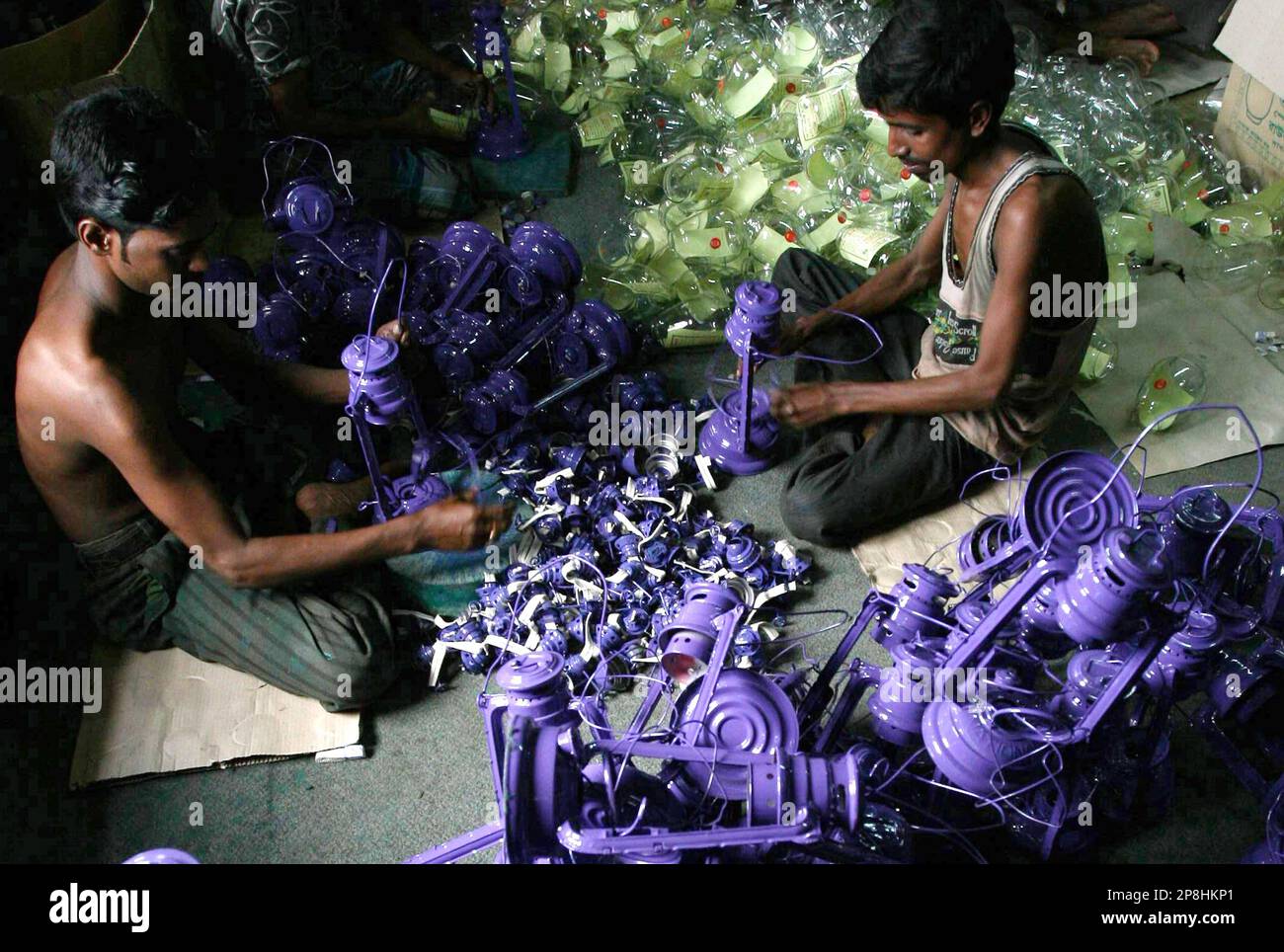 Bangladeshi worker produce oil lamps at a as the country faces