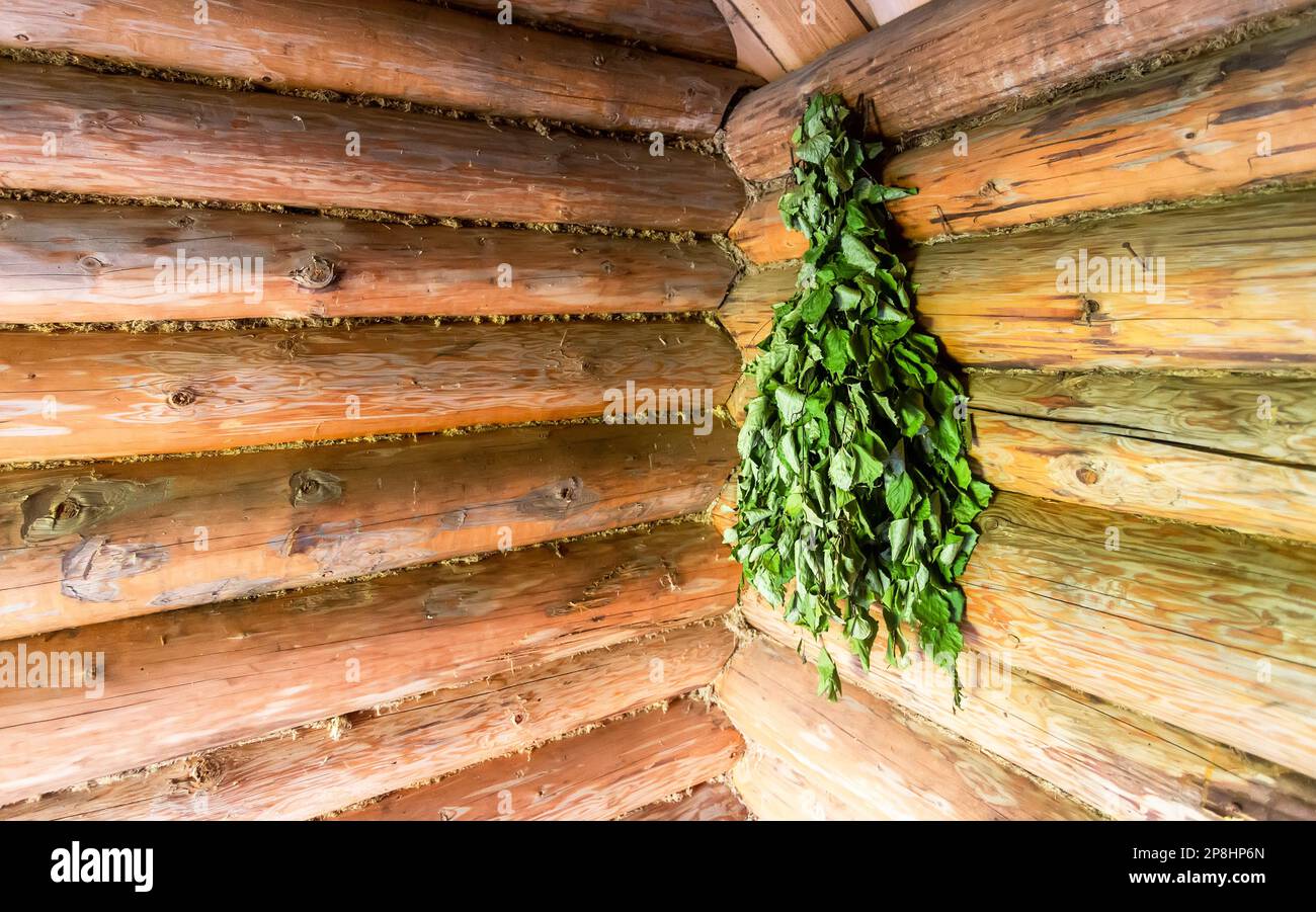 Birch dry broom for a steam room at the tradicional russian wooden bath house Stock Photo