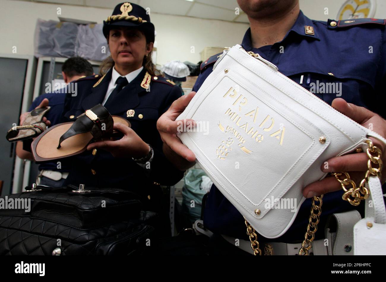 TO GO WITH MAFIA ERA DORADA ** This photo taken on June 11, 2008 shows  Italian police during a press conference holding fake Prada bags and shoes,  sized in Naples, Italy.