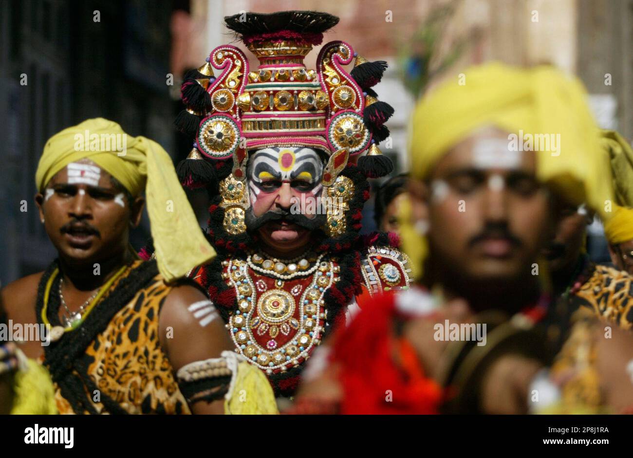 Artists from Karnataka state participate in a procession to mark ...