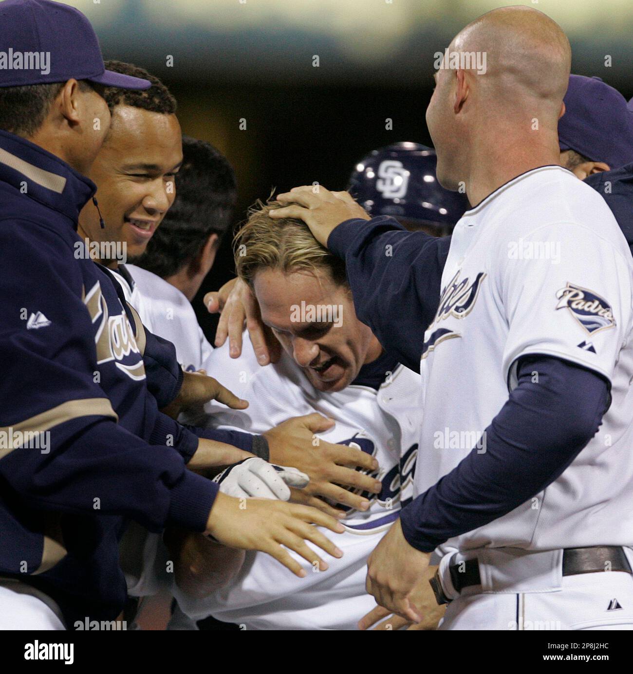 San Diego Padres' Brian Giles, center, is mobbed by teammates after his  game winning hit in the 11th inning gave the Padres a 4-3 victory over the  Pittsburgh Pirates during their baseball