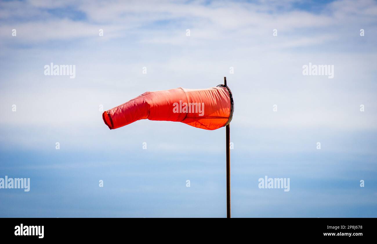 Orange windsock measures wind at airfield Stock Photo Alamy