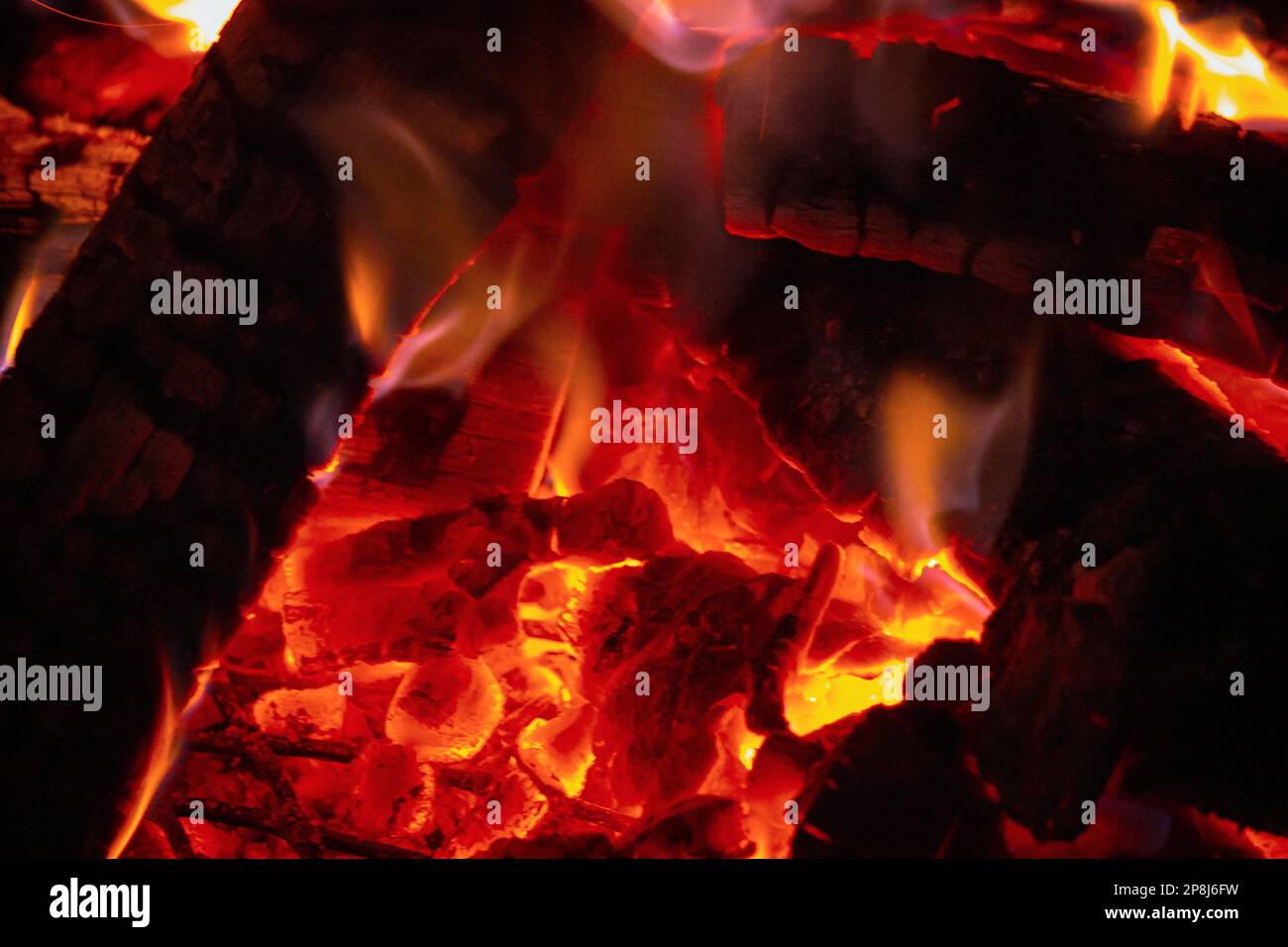 Wood burns in an evening fire Stock Photo Alamy