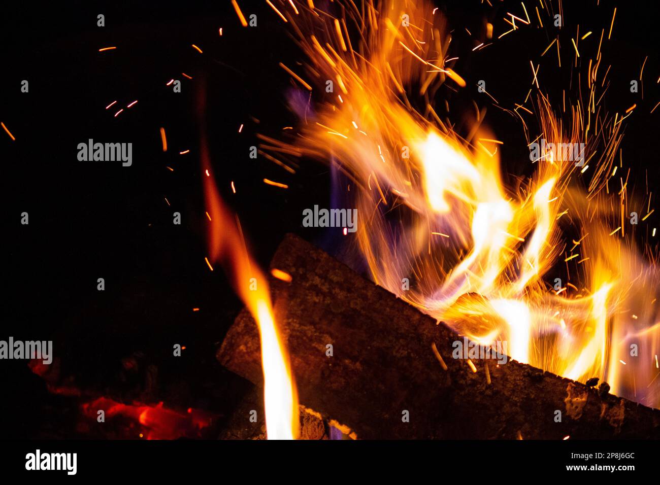 Sparks fly from a burning wood fire Stock Photo Alamy