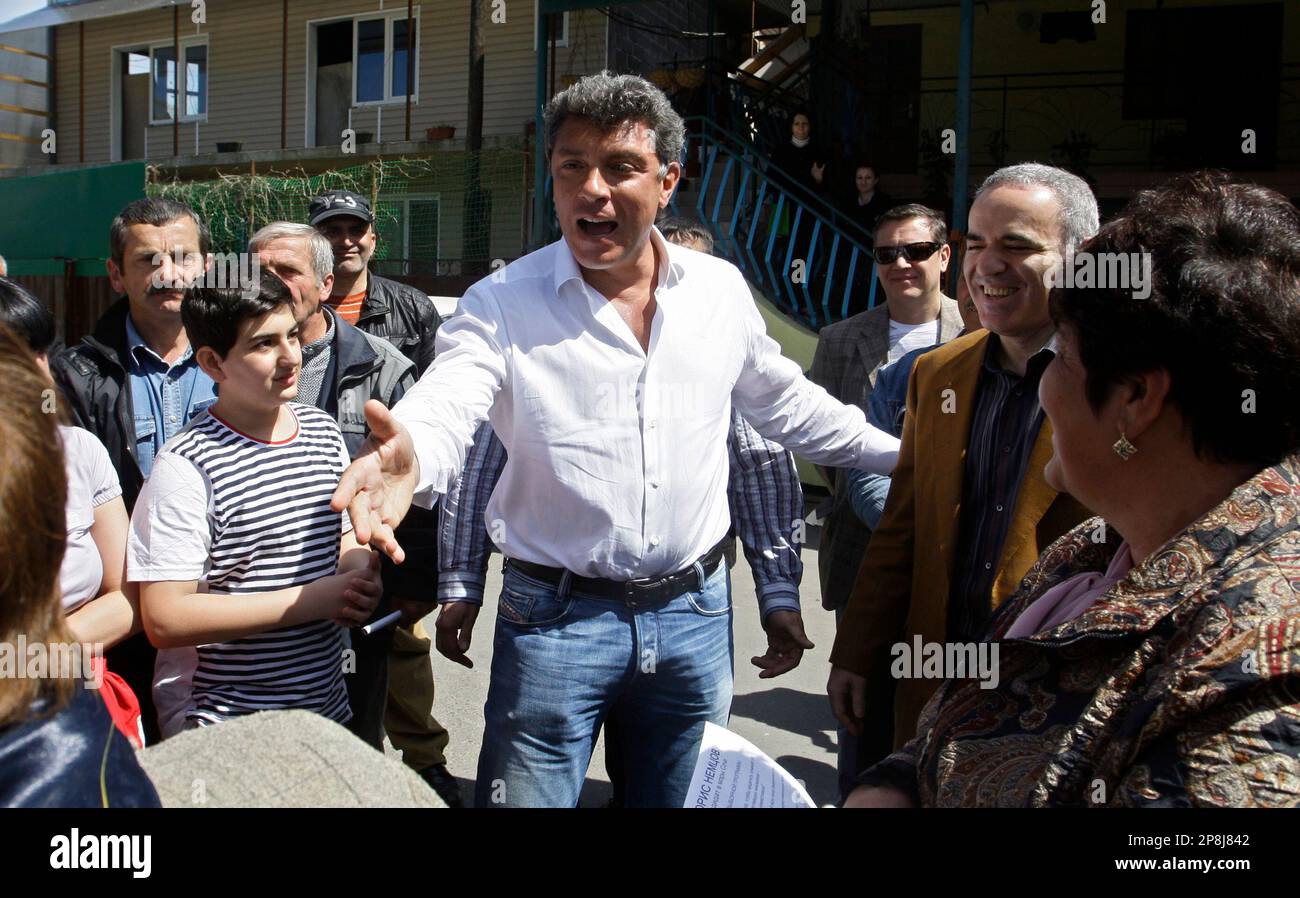 Former World Chess Champion, Garry Kasparov, right, talks to the media as  FIDE presidential candidate and former World Chess Champion, Anatoly Karpov,  left, and President of English Chess Federation, CJ de Mooi listen on  during their World Chess