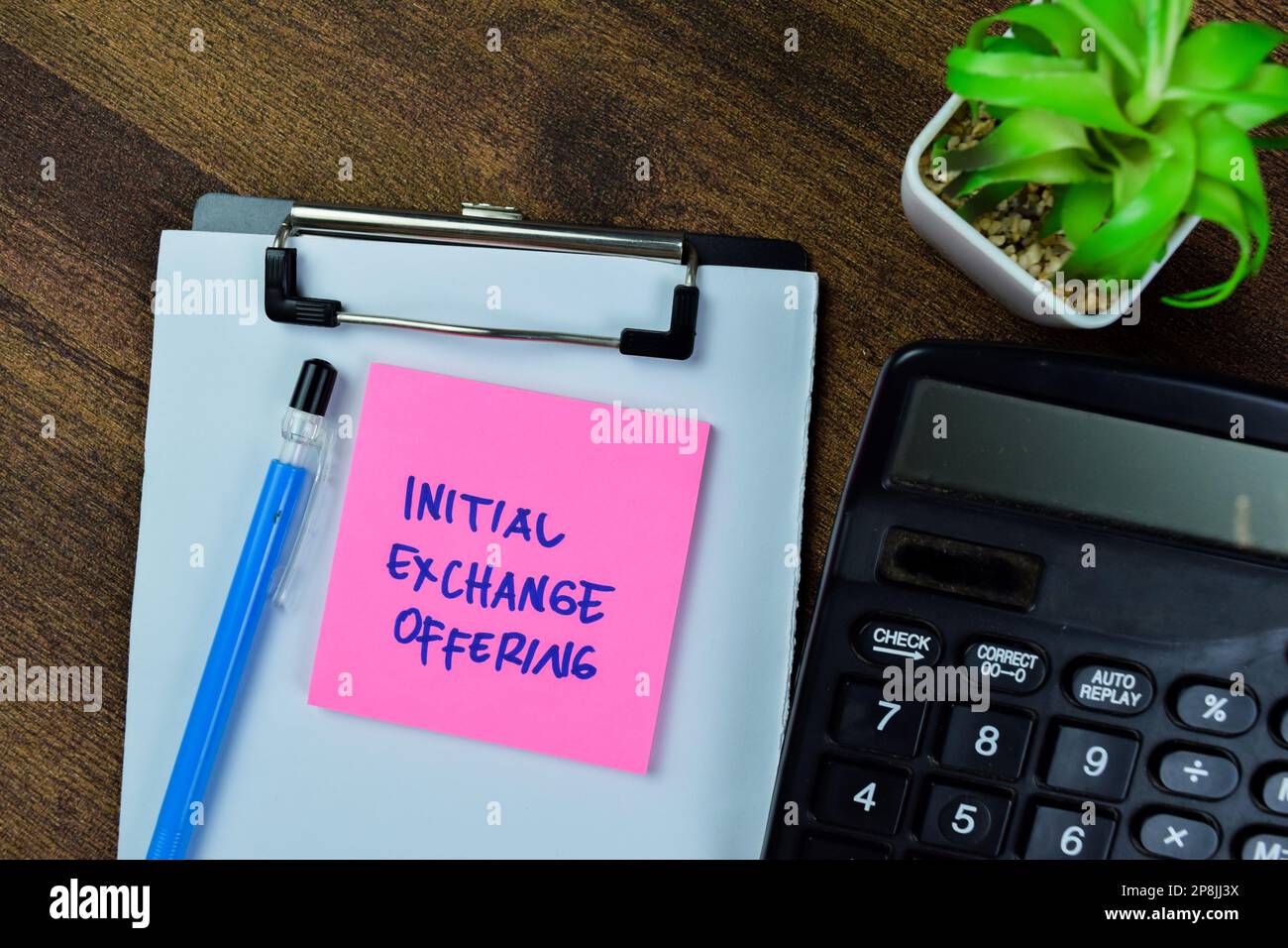 Concept of Initial Exchange Offering write on sticky notes isolated on Wooden Table. Stock Photo