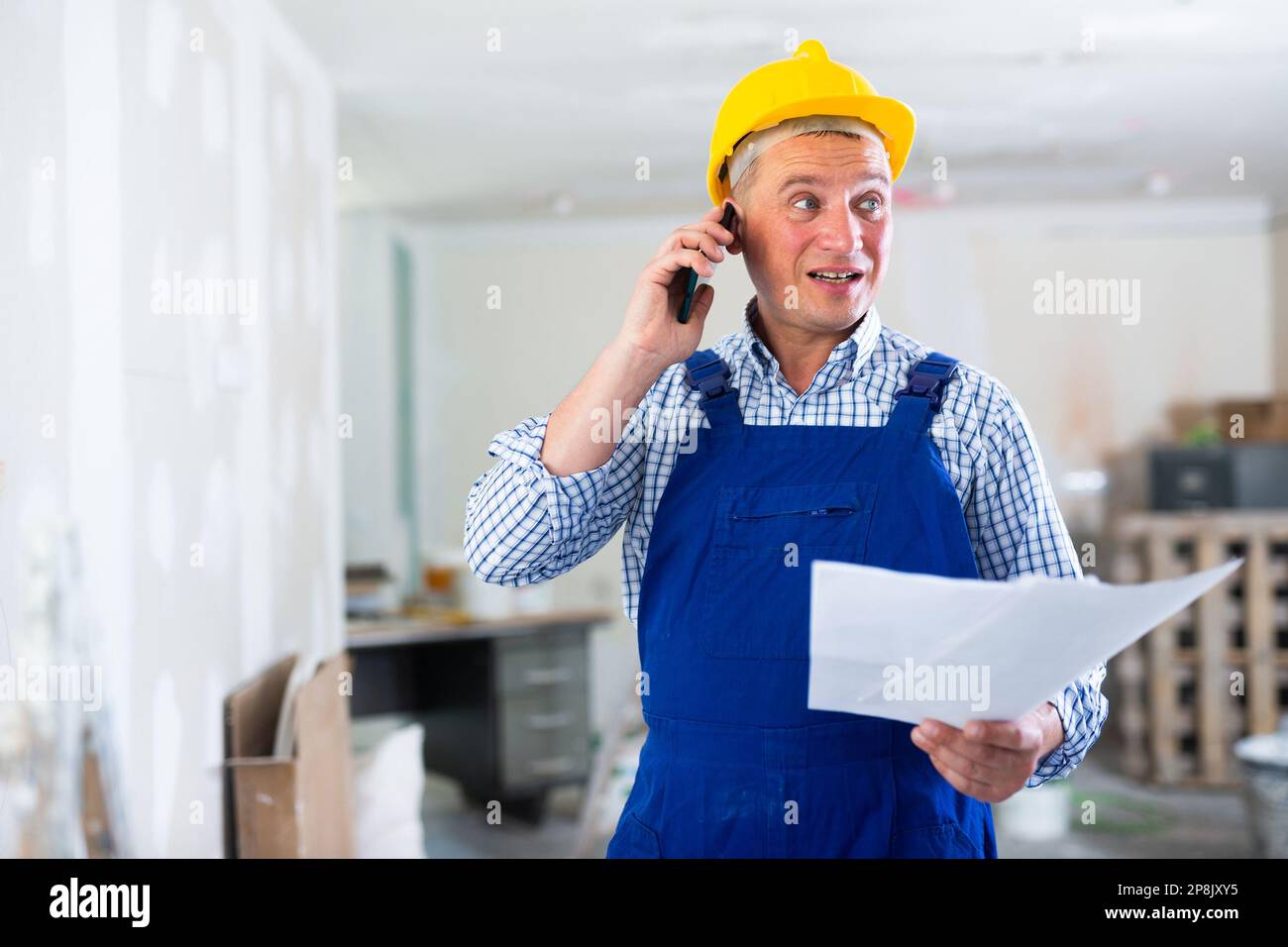 Construction worker having telephone conversation Stock Photo