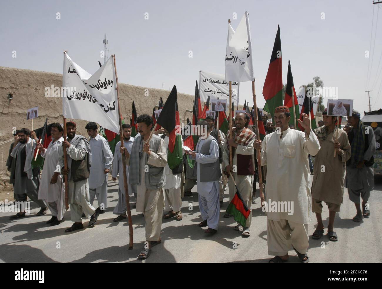Afghans march during a demonstration against the assassination of