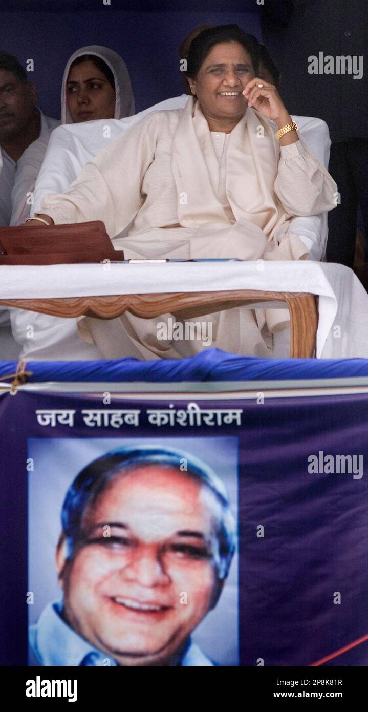 A portrait of mentor Kanshi Ram is seen as Bahujan Samaj Party president Mayawati, smiles during an election rally in Nuh, 75 kilometers (47 miles) from New Delhi, India, in this, April 6, 2009 photo. Mayawati, whose election symbol is an elephant, seeks national power as the larger parties stumble. (AP Photo/Manish Swarup). Stock Photo