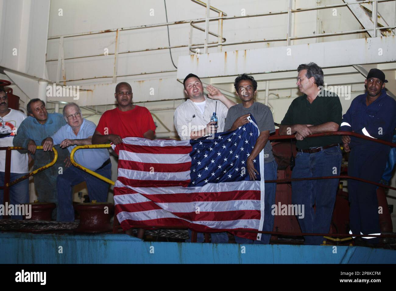 Crew members of the ship celebrate after their captain was released on