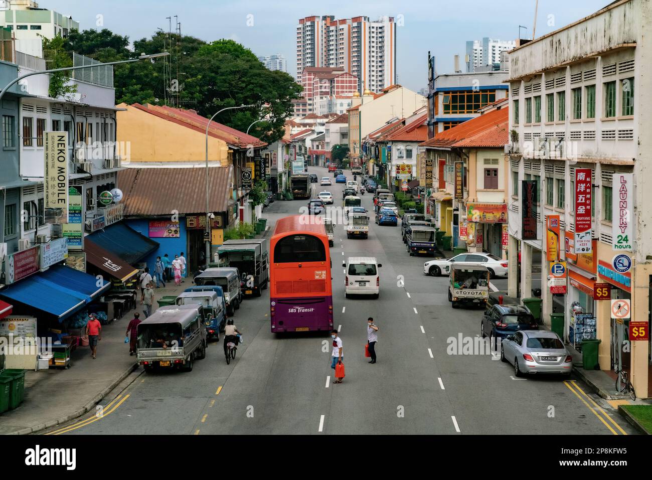 People rush through traffic crossing the road to the opposite side in Geylang, Singapore. Editorial Stock Photo