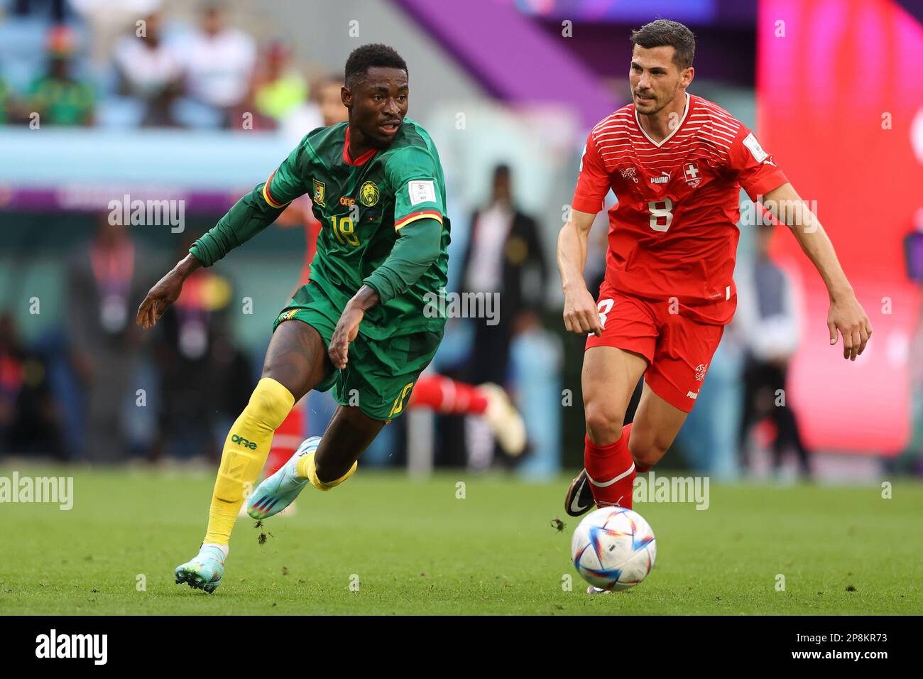 Martin Hongla of Cameroon (L) and Remo Freuler of Switzerland (R) in action during the FIFA World Cup Qatar 2022 match between Switzerland and Cameroon at Al Janoub Stadium. Final score: Switzerland 1:0 Cameroon. Stock Photo