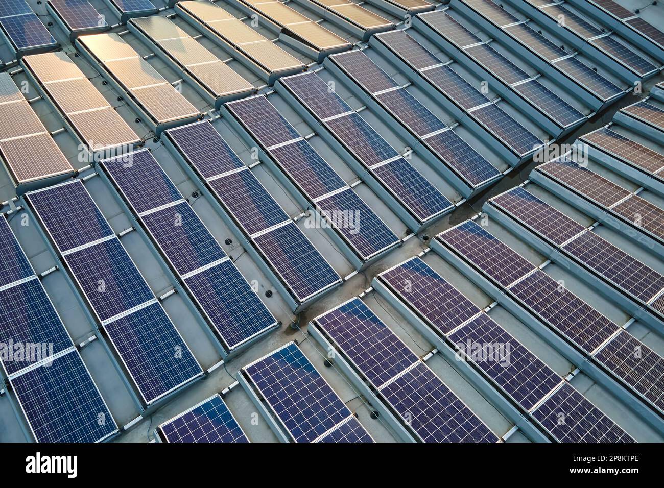 Aerial view of blue photovoltaic solar panels mounted on industrial ...