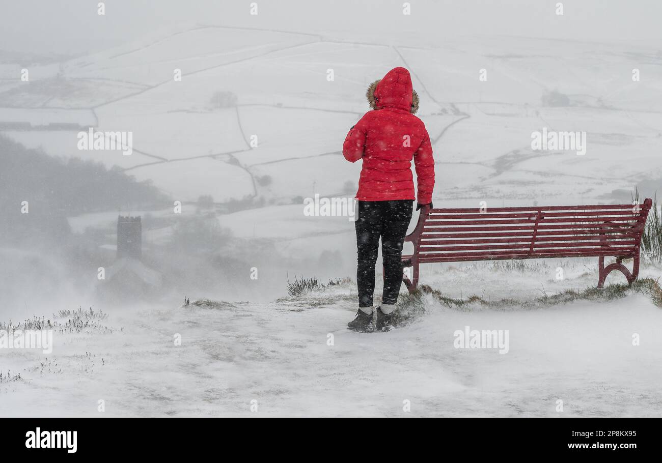 Haslingden, Lancashire, UK, Thursday March 09, 2023. A woman braves the blizzard like conditions above the town of Haslingden. The north of England is under a Met Office Amber Warning for snow and ice for the next 24 hours. Credit: Paul Heyes/Alamy News Live Stock Photo
