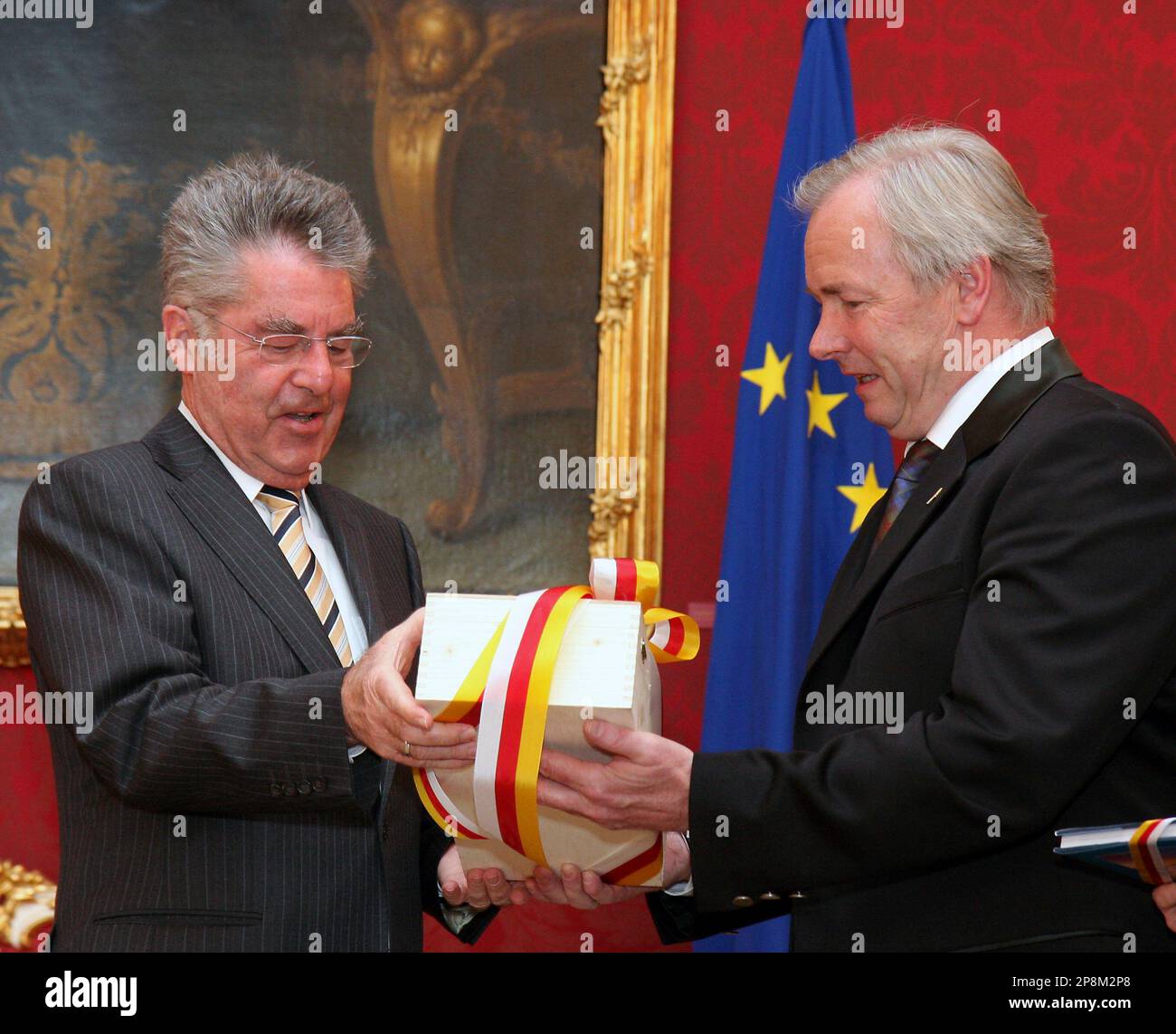 Austrian President Heinz Fischer, left, gets a gift from Gerhard Doerfler, right, the new Governor of Carinthia, before an inauguration ceremony at the Hofburg palace in Vienna, Austria, on Tuesday, April 7, 2009. (AP Photo/Ronald Zak) Stock Photo